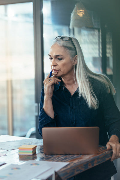 Business woman working over some reports at office