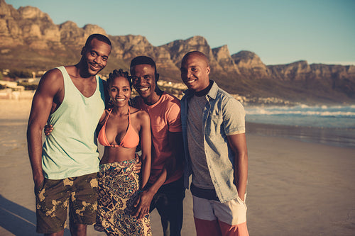 Young people standing together at beach