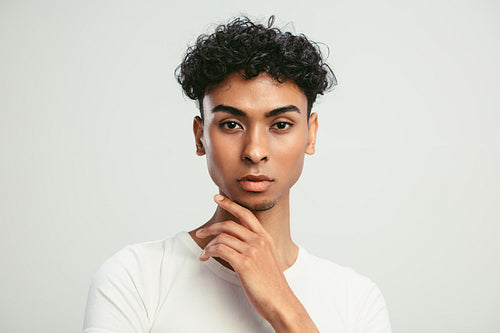 Portrait of an androgynous man on white background