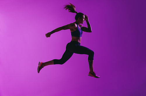 Side view of fit woman running