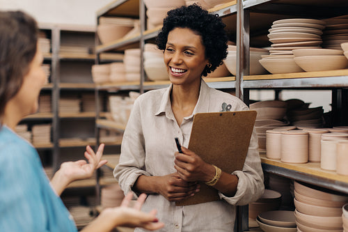 Female ceramic shop owners having a discussion in their store
