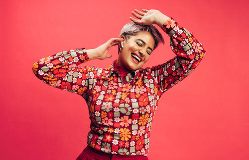 Carefree young woman dancing to her favourite song