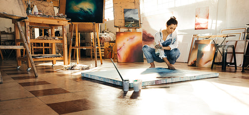Artist working on a new painting in her studio