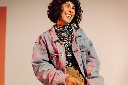 Fashionable young woman laughing happily