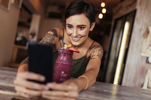 Woman taking a selfie for her food blog