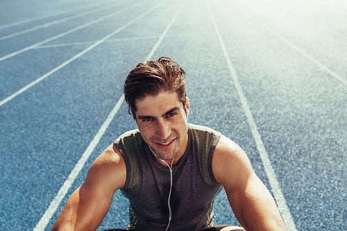 Sprinter relaxing on running track