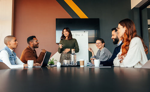 Cheerful businesswoman giving a presentation in a boardroom