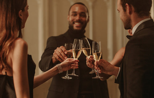Group of friends celebrating with champagne at a party