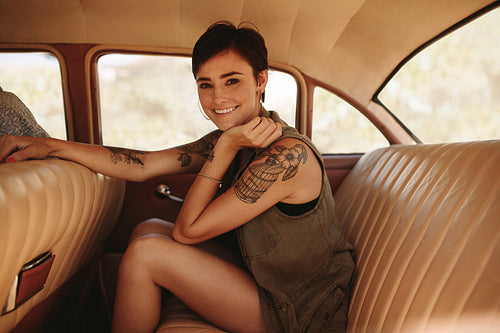 Woman traveling by vintage car 