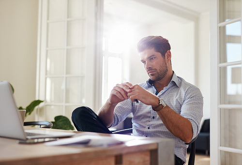 Thoughtful businessman working at home office