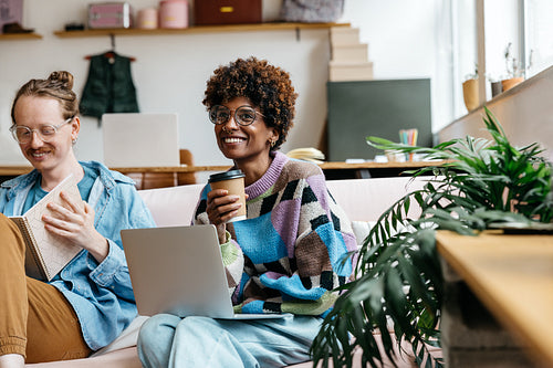 Smiling colleagues working in a modern freelance co-working space