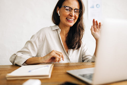 Business woman engaging in an online meeting using a laptop