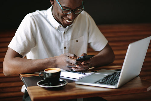 Man doing work sitting in a coffee shop
