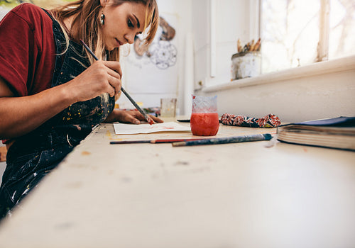 Woman drawing pictures in her workshop
