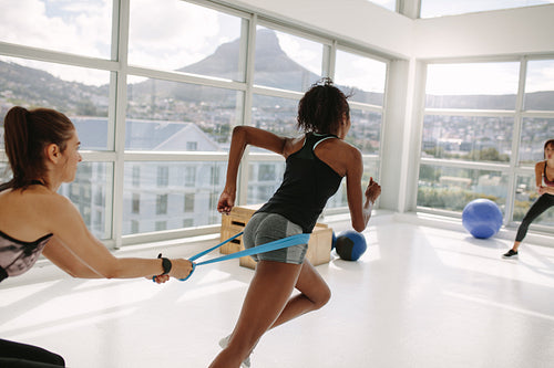 Women at gym during resistance band workout