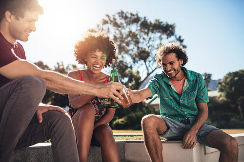 Multiracial group of friends having drinks outside