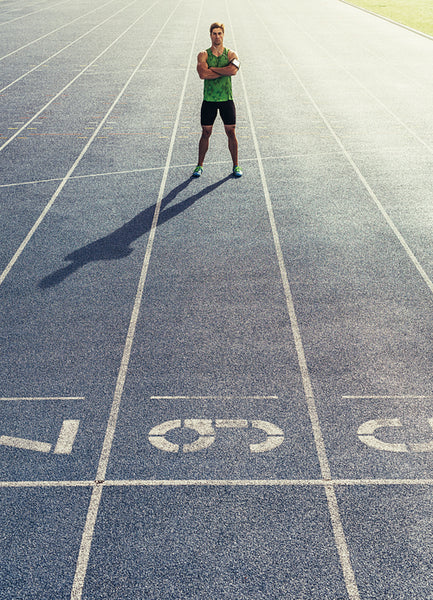 Sprinter standing on running track