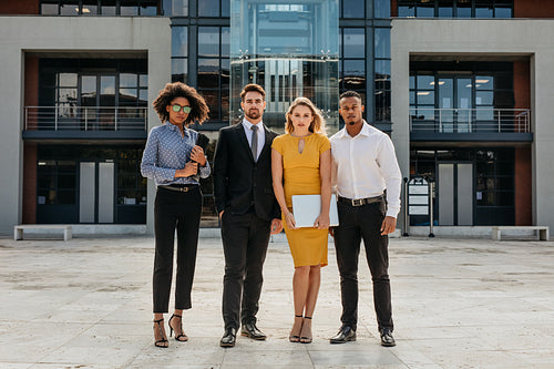 Corporate professionals in front a modern office building