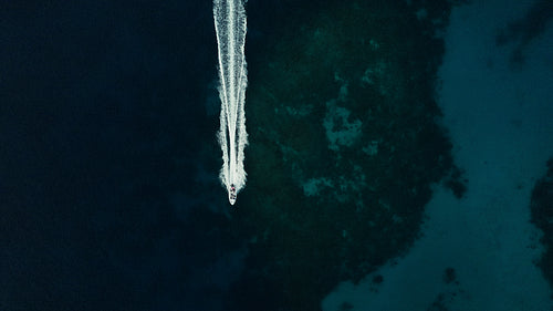 Speedboat cruises across pristine blue water