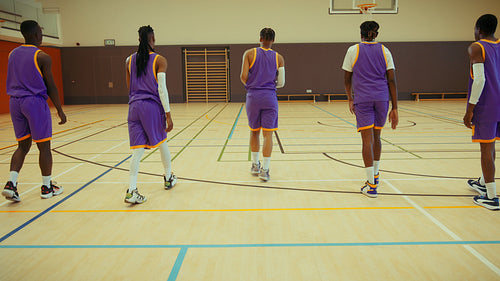 Basketball team performing dynamic stretches