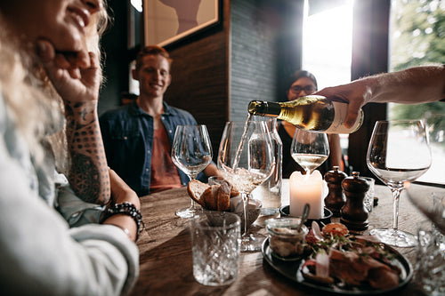 Group of young people having drinks at restaurant
