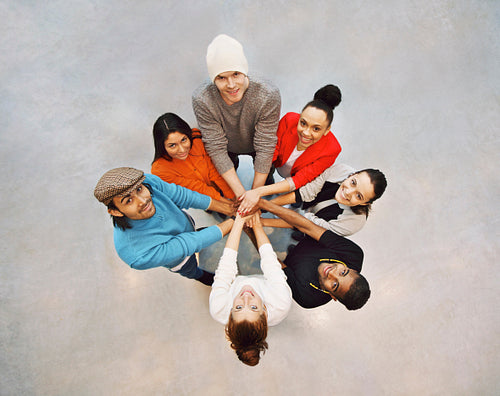 Happy young students showing unity as a team