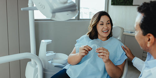 Patient and dentist discuss a dental aligner during consultation in the clinic