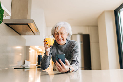 Retired woman speaking on a video call at home