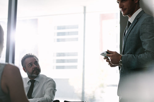 Executive talking with colleagues during a meeting
