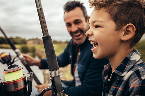 Father and son fishing near the lake