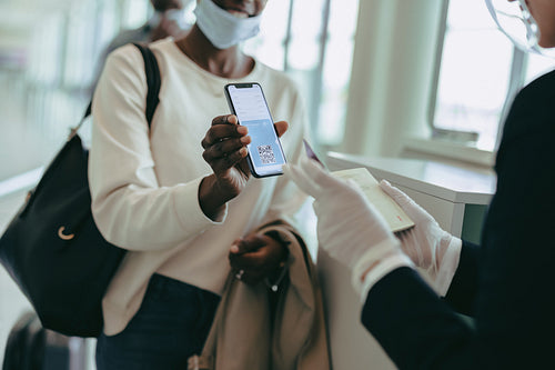 Ground attendant checking medical pass of passenger