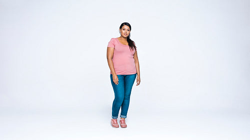 Young woman standing against white background