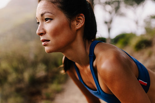 Female runner in sportswear taking a break