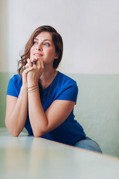 Thoughtful young woman sitting at a table