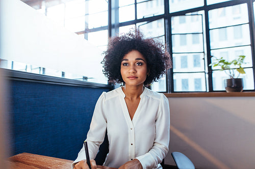 Businesswoman sitting at her desk and working in office