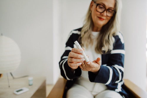Diabetes patient uses a lancet for glucose testing