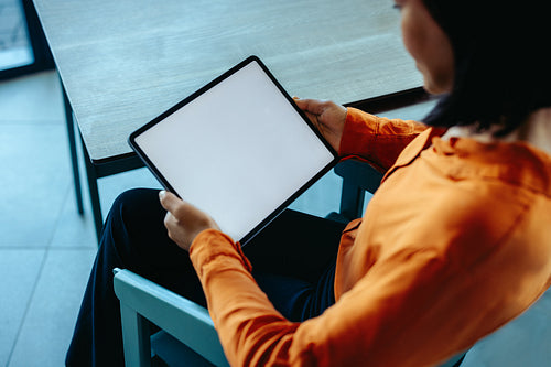 Businesswoman using a tablet in modern office setting