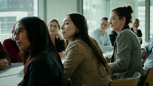 Business professionals listening in meeting