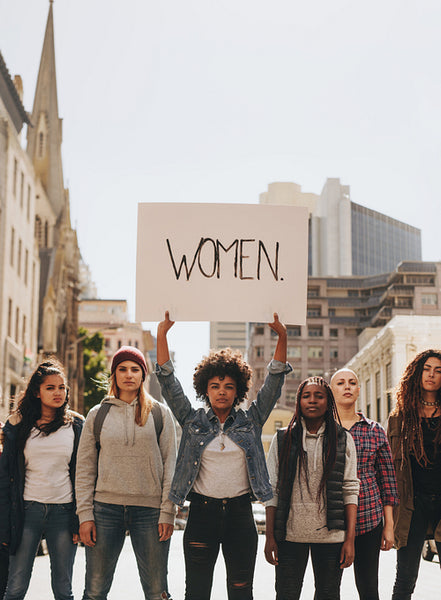 Demonstrators with a sign protesting on road