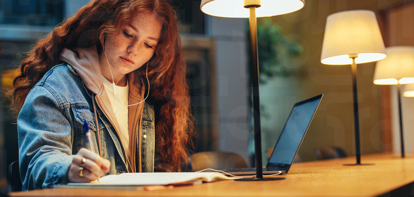 Student completing her college assignment in library – Jacob Lund ...