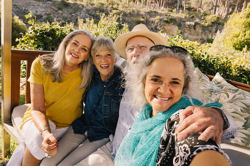 Happy elderly friends taking a selfie together during vacation