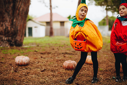Identical twins ready for treat or tricking on halloween