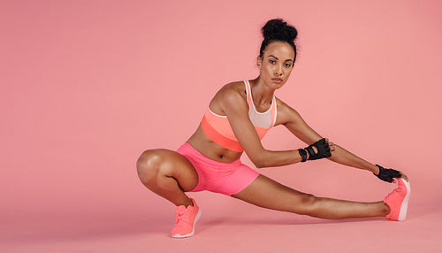Healthy woman doing stretching exercises in studio.