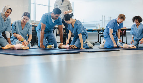 Nursing and medical students undergoing training with baby CPR manikins
