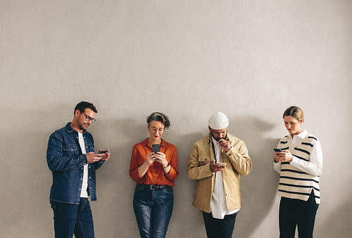 Businesspeople using their smartphone in a waiting area