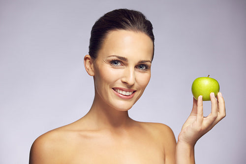 Beautiful woman holding green apple