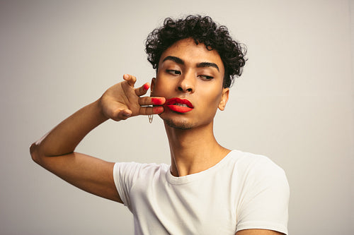 Transgender male smudging his lipstick