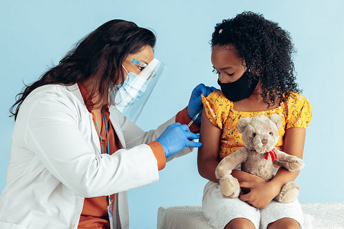 Doctor vaccinating girl