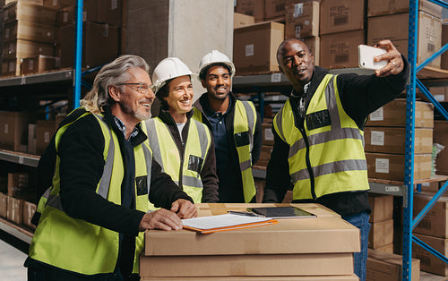Happy warehouse team taking a selfie together