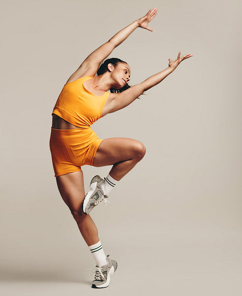 Flexible female athlete displaying impressive balance and agility in a gymnastic workout pose